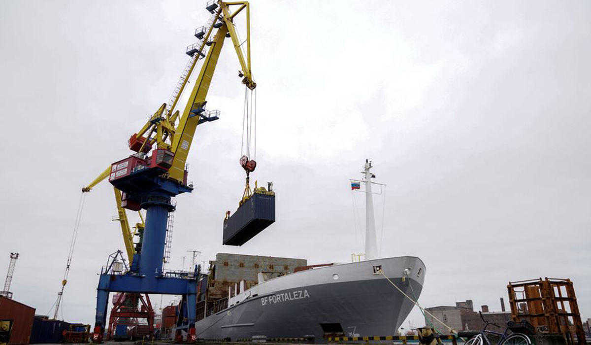 A crane lifts a shipping container